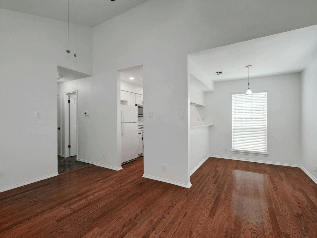 913 Sirocco Drive, Unit A & B Austin, TX 78745 - Photo 3 of 39 an empty room with wooden floor and windows