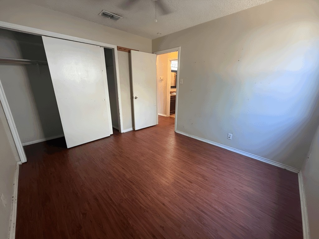 913 Sirocco Drive, Unit A & B Austin, TX 78745 - Photo 31 of 39 an empty room with wooden floor and windows