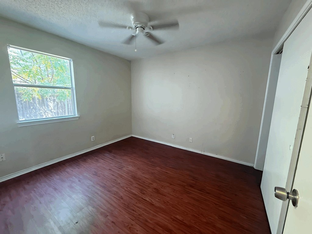913 Sirocco Drive, Unit A & B Austin, TX 78745 - Photo 32 of 39 a view of an empty room with wooden floor and a window