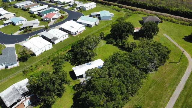 an aerial view of a residential houses with outdoor space and swimming pool