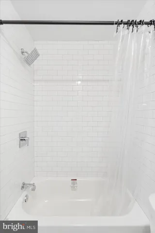 a bathroom with a shower and a bathtub