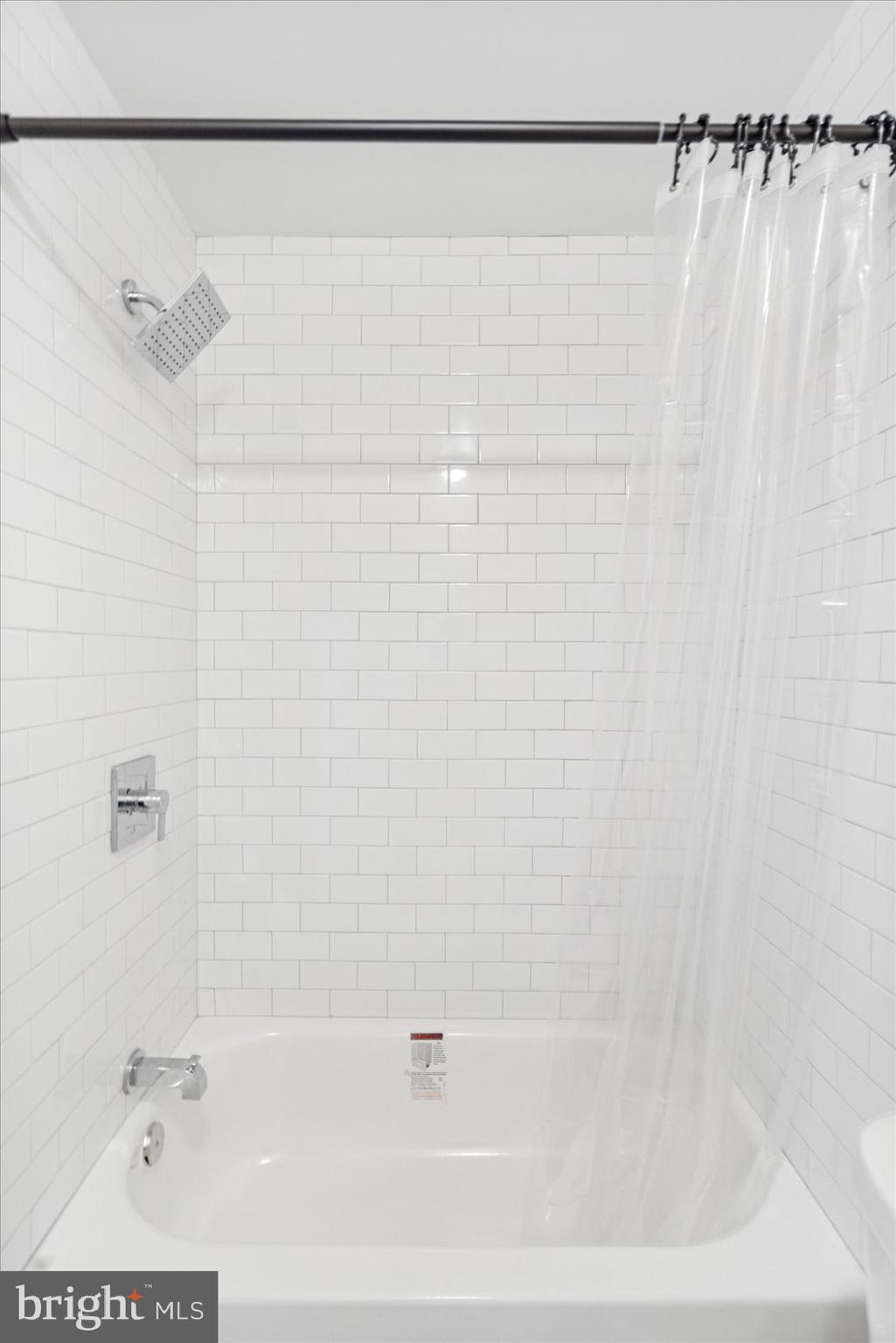 3205 Esther Place Baltimore, MD 21224 - Photo 11 of 32 a bathroom with a shower and a bathtub