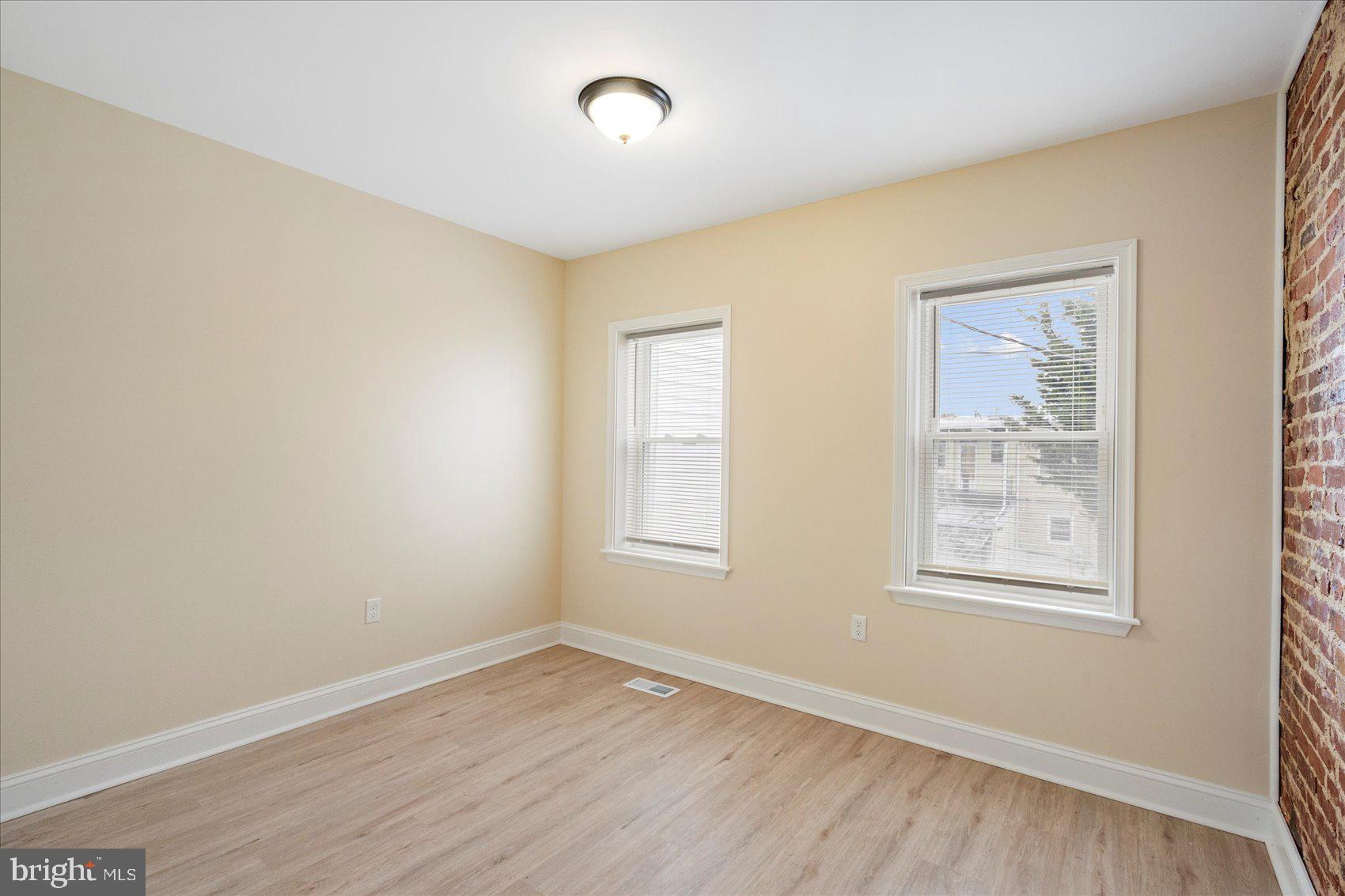 3205 Esther Place Baltimore, MD 21224 - Photo 15 of 32 a view of an empty room with wooden floor and a window