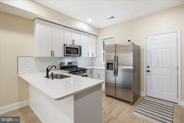 a kitchen with a refrigerator sink and microwave