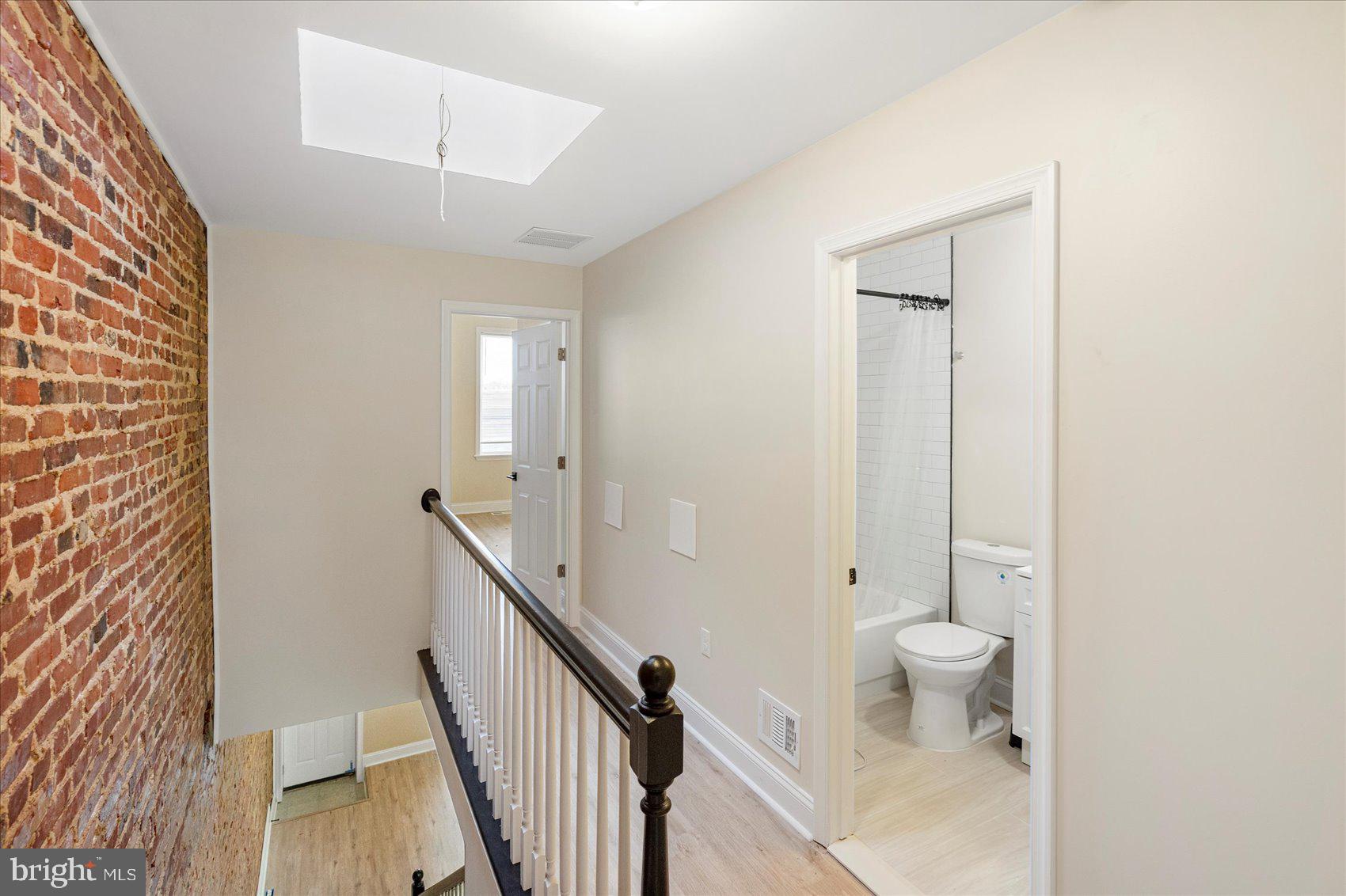 3205 Esther Place Baltimore, MD 21224 - Photo 3 of 32 a very nice looking room with wooden floor and a bathroom