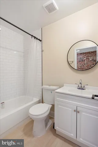 a bathroom with a toilet a sink and bathtub