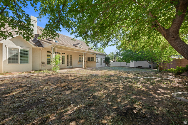 20 Valley Road Leeds, UT 84746 - Photo 34 of 57 Expansive backyard with a covered patio, multiple entry points via French doors, and mature trees providing natural shade