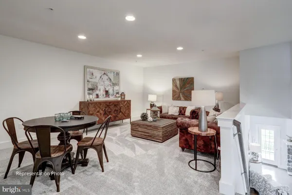 a living room with furniture and a rug