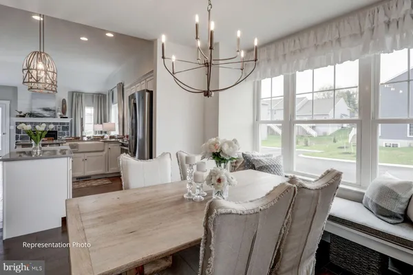a view of a dining room with furniture wooden floor and chandelier