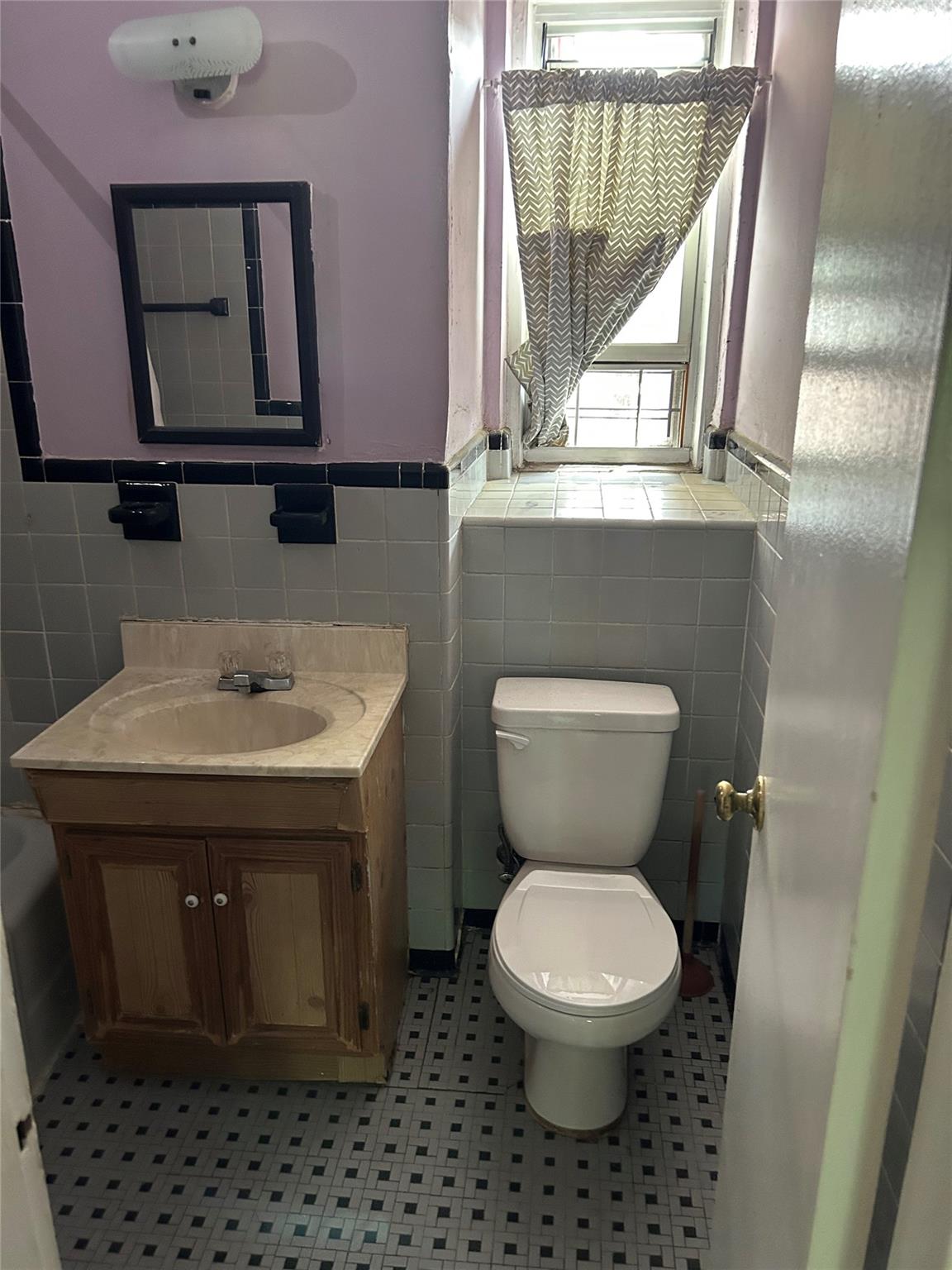 4265 Webster Avenue, Unit 7D Bronx, NY 10470 - Photo 7 of 14 a bathroom with a toilet sink and mirror