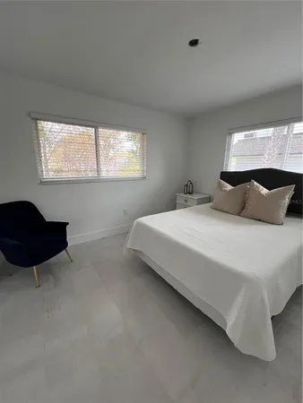 a bedroom with bed and a couch