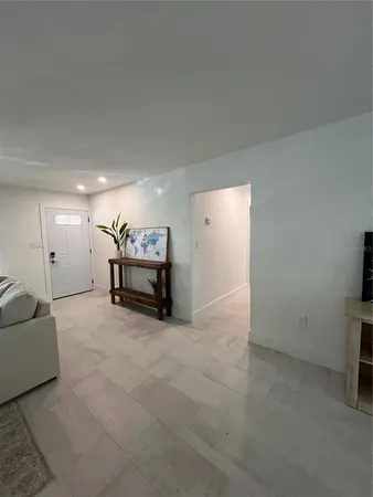 a large white kitchen with stainless steel appliances granite countertop a sink and cabinets