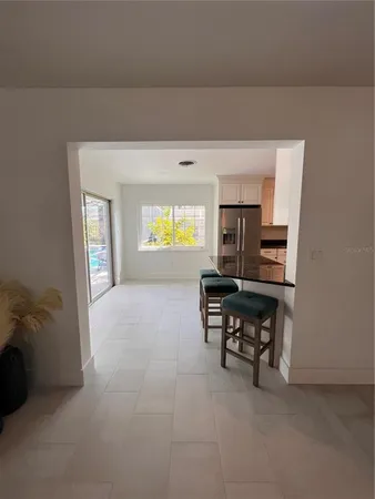 a large kitchen with granite countertop a stove and a sink