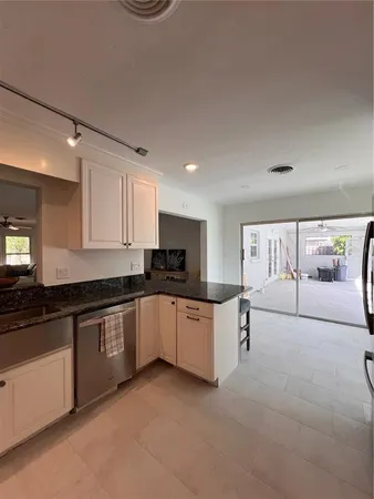a living room with furniture and a ceiling fan