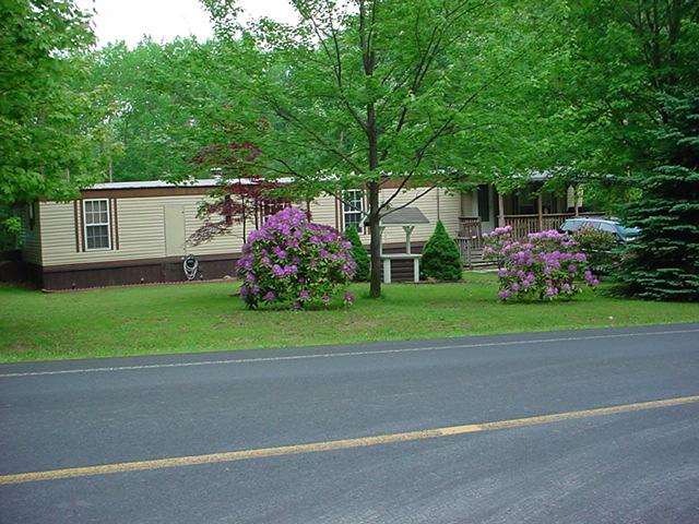 206 Sun Valley Mountain Road Effort, PA 18330 - Photo 1 of 1 a front view of a house with a garden and trees