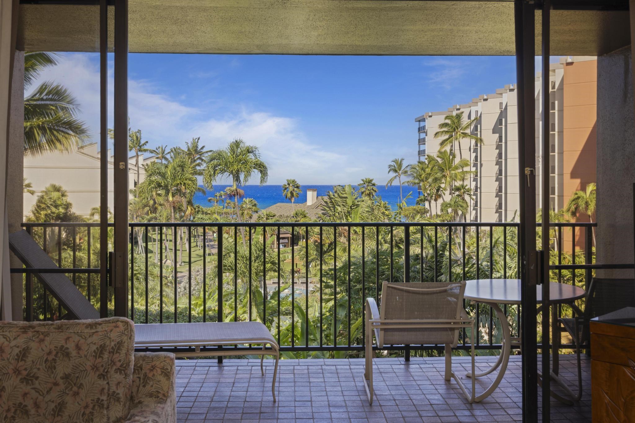 3445 Lower Honoapiilani Road, Unit 431 Lahaina, HI 96761 - Photo 2 of 32 a balcony with wooden floor and outdoor seating