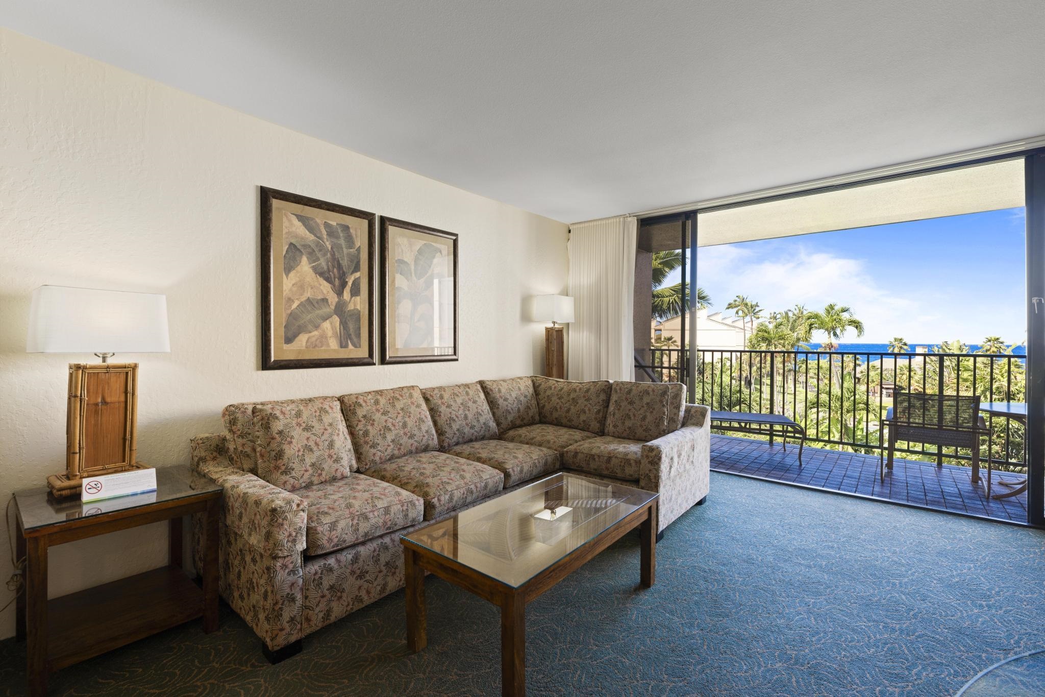 3445 Lower Honoapiilani Road, Unit 431 Lahaina, HI 96761 - Photo 3 of 32 a living room with furniture and a floor to ceiling window
