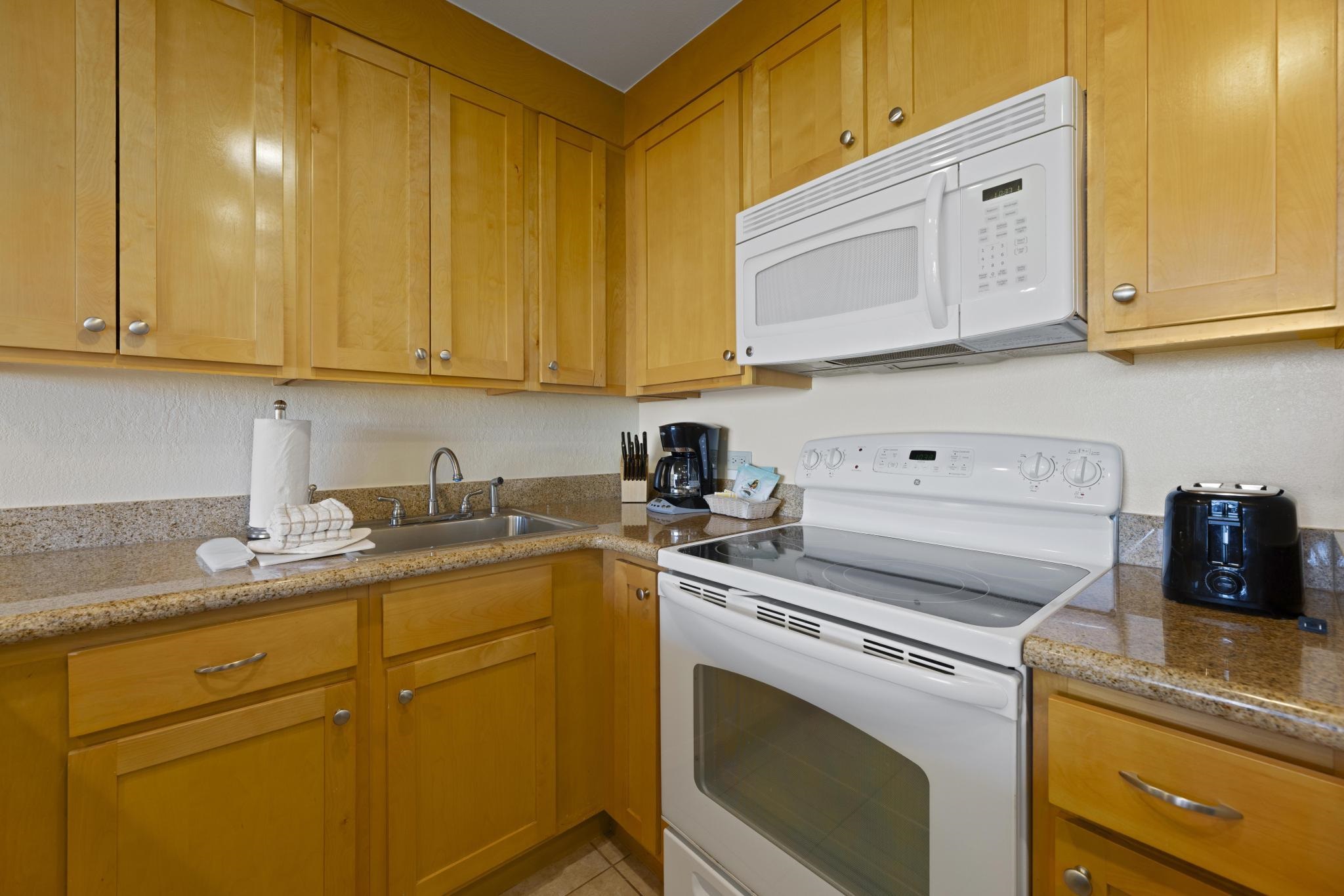 3445 Lower Honoapiilani Road, Unit 431 Lahaina, HI 96761 - Photo 7 of 32 a kitchen with stainless steel appliances granite countertop a sink a stove and cabinets