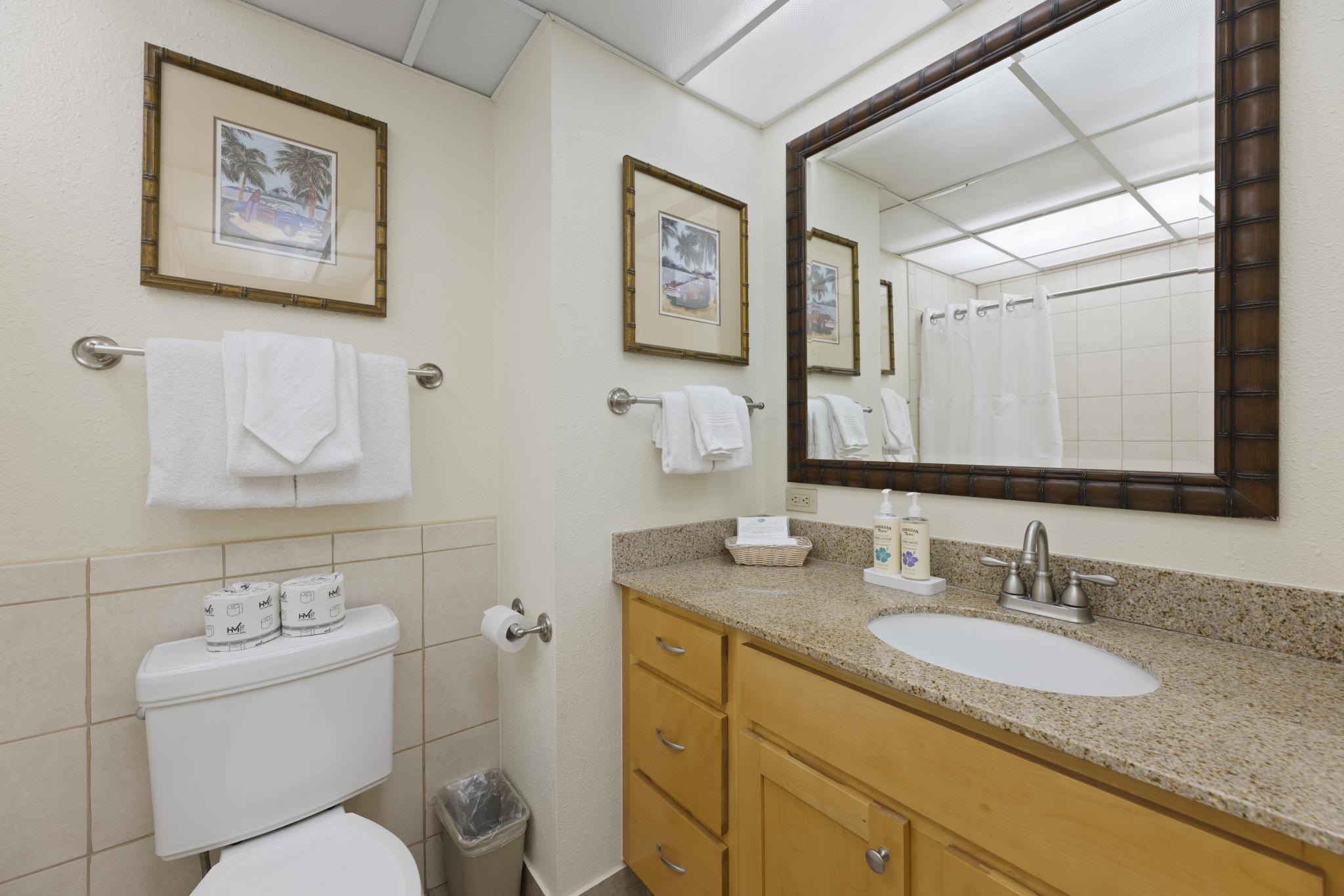 3445 Lower Honoapiilani Road, Unit 431 Lahaina, HI 96761 - Photo 9 of 32 a bathroom with a granite countertop toilet sink and mirror