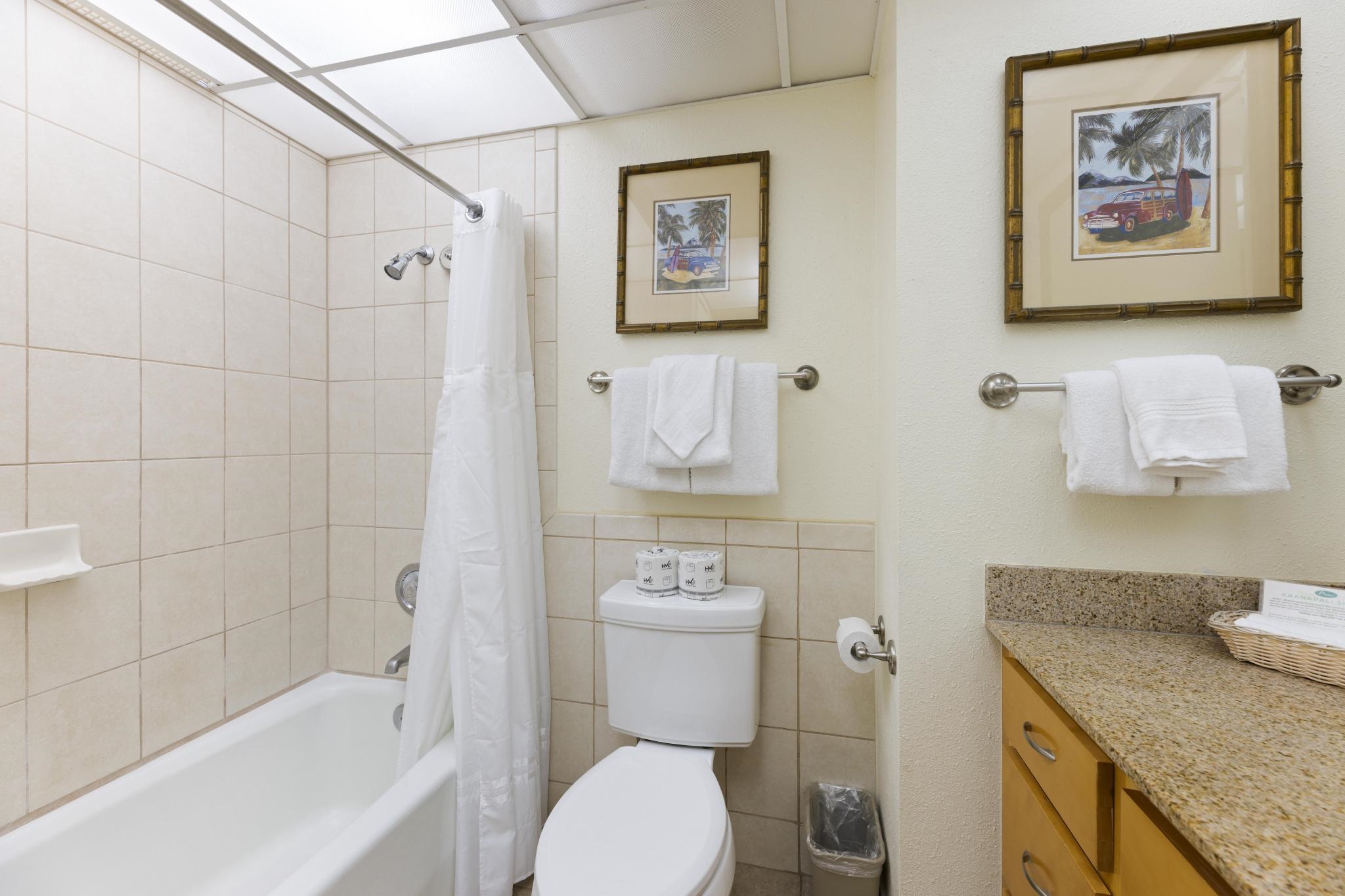 3445 Lower Honoapiilani Road, Unit 431 Lahaina, HI 96761 - Photo 10 of 32 a bathroom with a granite countertop toilet a sink and bathtub