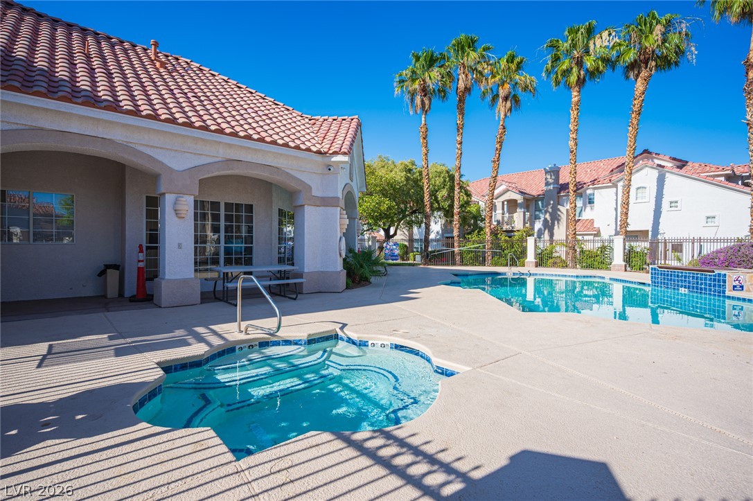 8555 West Russell Road, Unit 2062 Las Vegas, NV 89113 - Photo 34 of 35 Relax poolside at this community oasis, featuring a sparkling pool, soothing spa, and inviting patio area.