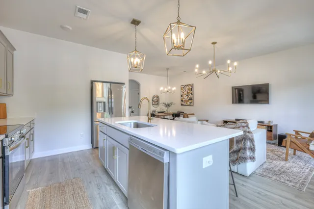 a large kitchen with kitchen island a sink and a stove top oven