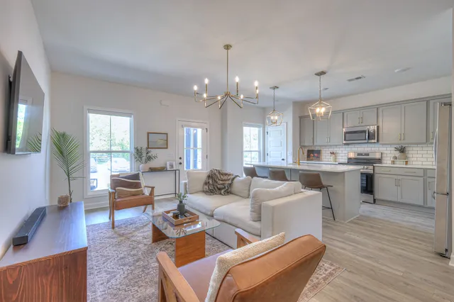 a living room with furniture and a wooden floor