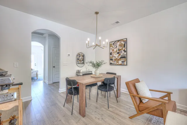 a view of a dining room with furniture wooden floor and a chandelier