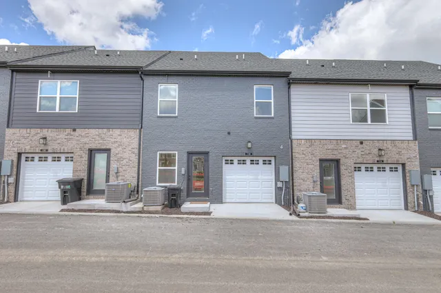 a front view of a house with a road