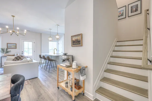 a living room with furniture and a chandelier