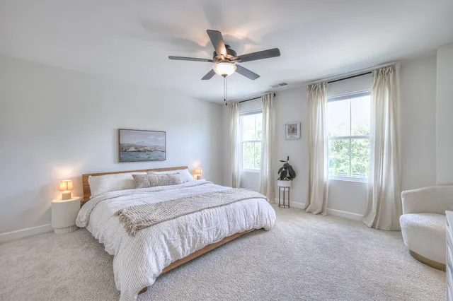 a bedroom with a large bed and a chandelier