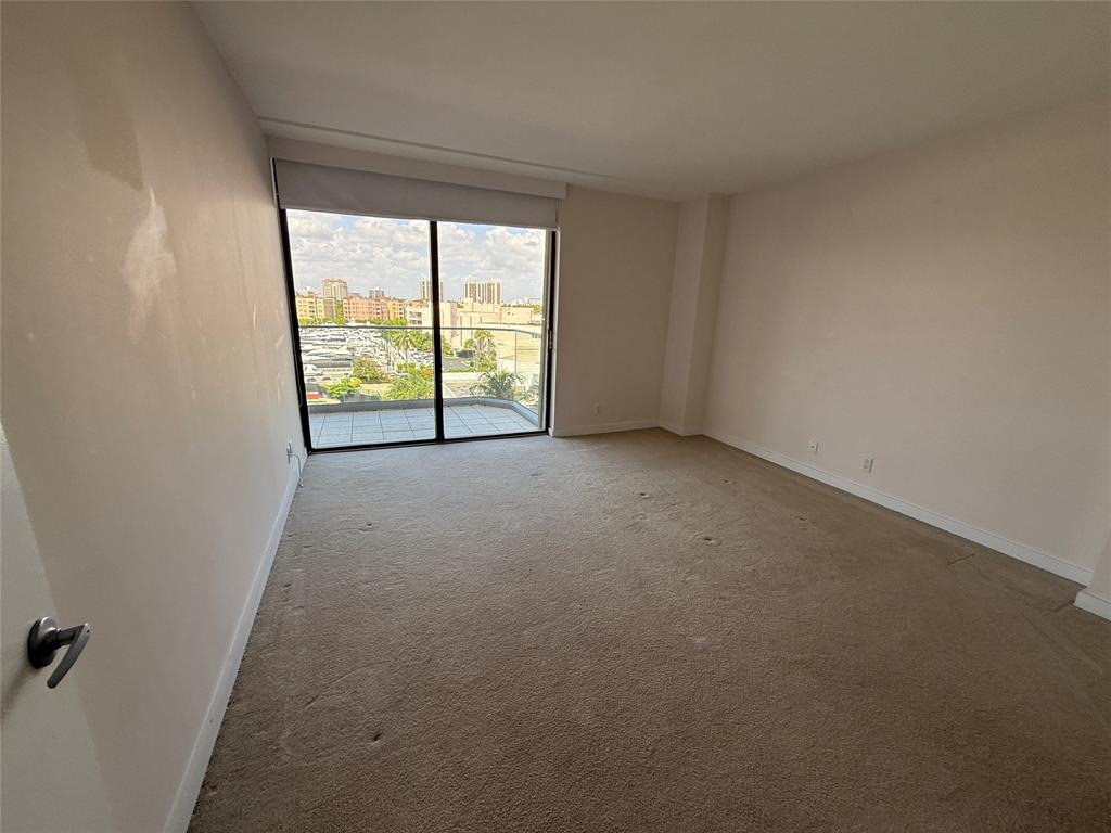 19707 Turnberry Way, Unit 7C Aventura, FL 33180 - Photo 12 of 40 an empty room with windows