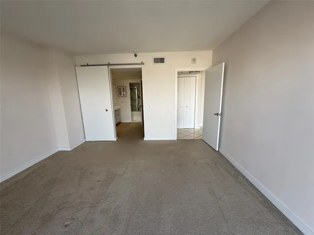 a spacious bathroom with a granite countertop sink a mirror and a bathtub
