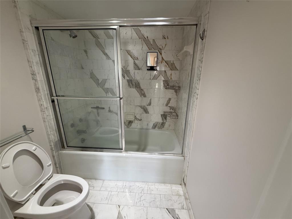 19707 Turnberry Way, Unit 7C Aventura, FL 33180 - Photo 15 of 40 a bathroom with a shower and a toilet