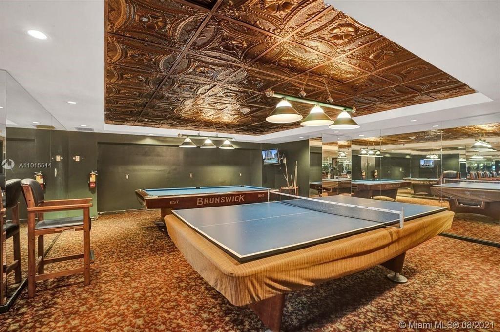 19707 Turnberry Way, Unit 7C Aventura, FL 33180 - Photo 34 of 40 a view of a patio with a table and chairs