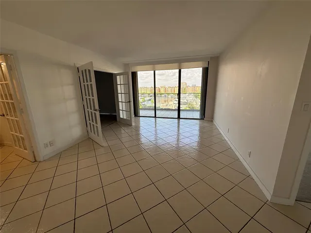 a kitchen with granite countertop white cabinets and stainless steel appliances
