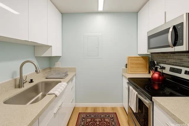 a kitchen with a sink stove and microwave