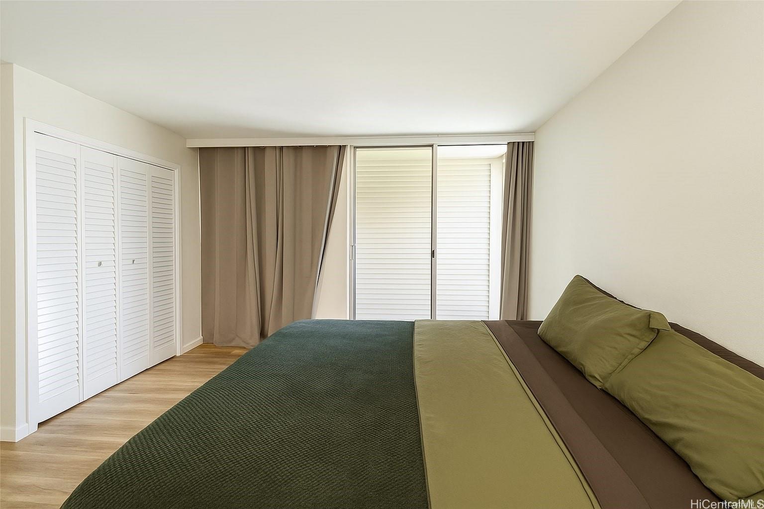 775 Kinalau Place, Unit 1408 Honolulu, HI 96813 - Photo 6 of 12 a bedroom with a bed and a window