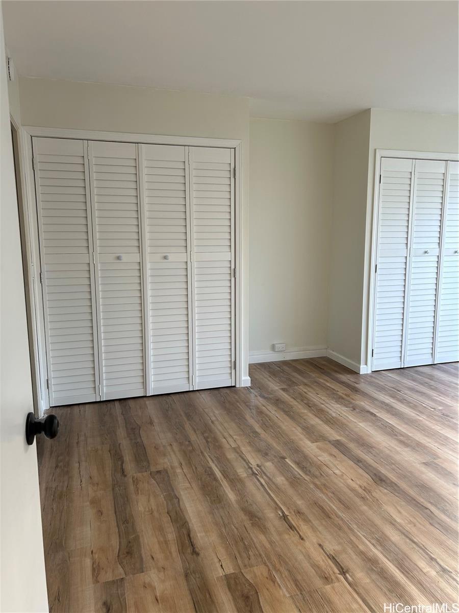 775 Kinalau Place, Unit 1408 Honolulu, HI 96813 - Photo 9 of 12 a view of an empty room with wooden floor