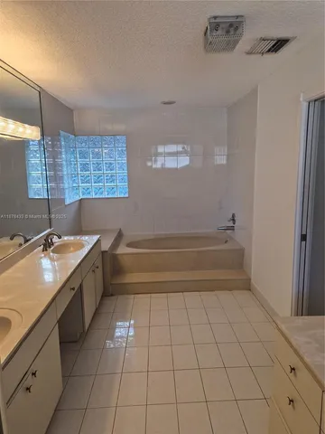 a view of a backyard with a swimming pool and sitting area