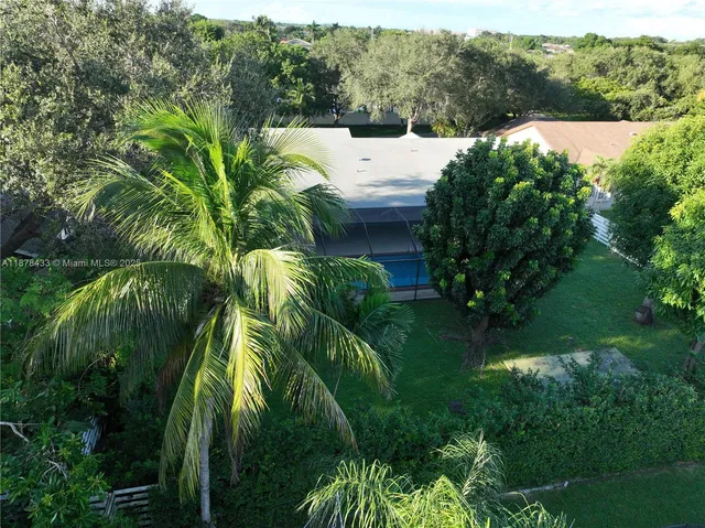 a view of backyard with a garden and deck
