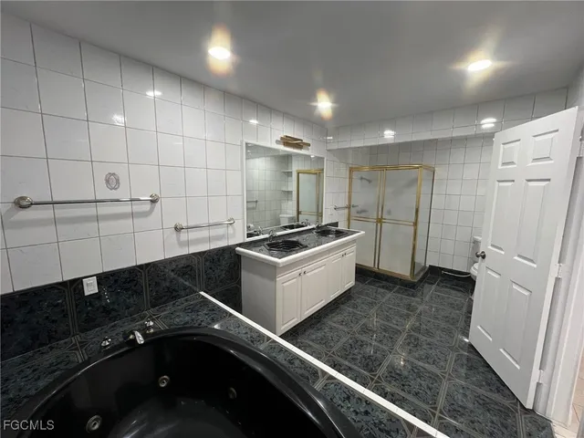 a kitchen with a refrigerator and white cabinets