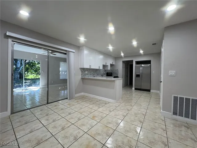 a kitchen with stainless steel appliances granite countertop a refrigerator and a sink