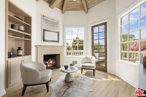 a living room with furniture a window and a fireplace