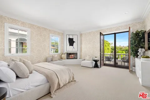 a bedroom with furniture and a large window