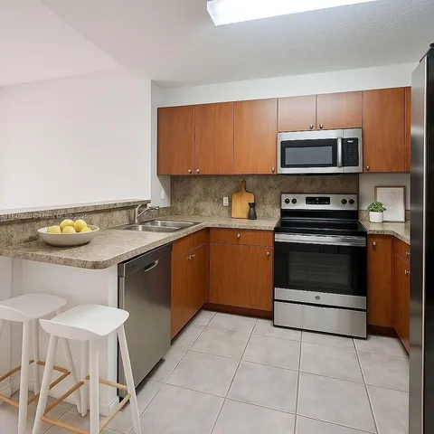 a kitchen with a sink cabinets and stainless steel appliances