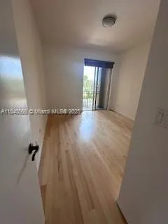 a view of a room with wooden floor and windows
