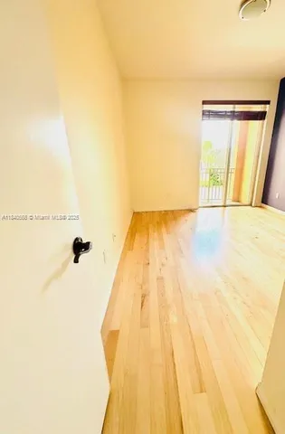 a view of a room with wooden floor