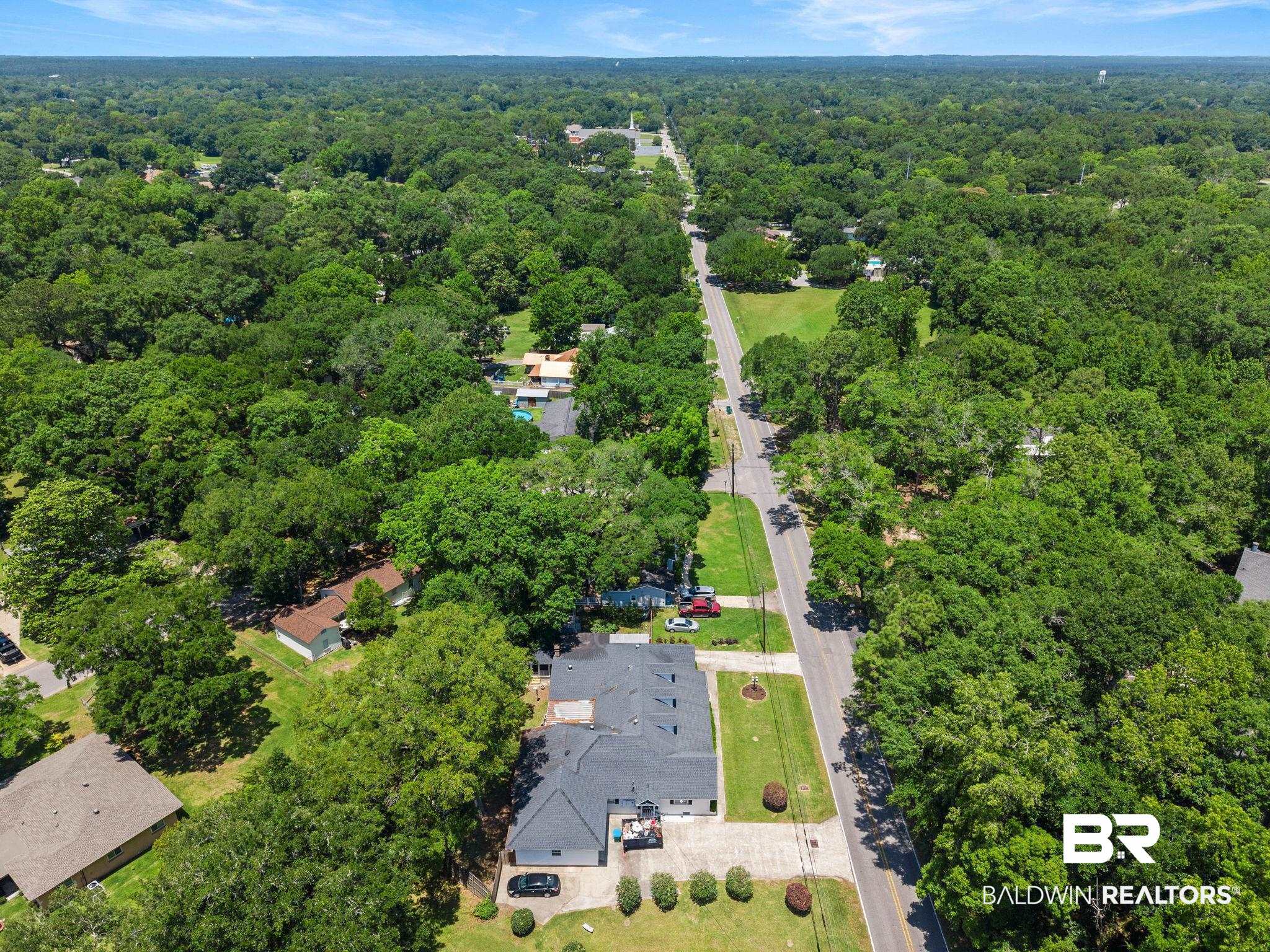 927 Cleveland Road Saraland, AL 36571 - Photo 79 of 80 Expansive property featuring a paved parking area and mature landscaping
