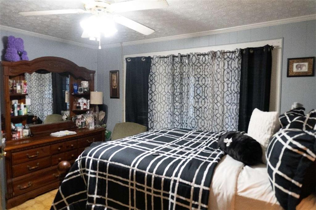 525 East 14th Street Rome, GA 30161 - Photo 6 of 12 a bedroom with a bed and a chandelier